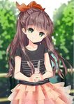  alci-chan blurry blurry_background bow brown_hair day green_eyes hair_bow highres interlocked_fingers long_hair looking_at_viewer outdoors pink_skirt railing red_bow shirt skirt smile solo standing t-shirt tree 