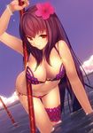 bikini bracelet breasts cleavage cloud commentary dutch_angle fate/grand_order fate_(series) flower hair_flower hair_ornament hibiscus highres jewelry large_breasts leaning_forward long_hair looking_at_viewer machimura_komori navel polearm red_eyes revision scathach_(fate)_(all) scathach_(swimsuit_assassin)_(fate) side-tie_bikini skindentation smile solo swimsuit thigh_gap wading weapon wet 