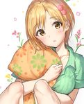  aiba_yumi bangs blonde_hair blush brown_eyes collarbone commentary_request floral_print flower green_shirt hair_flower hair_ornament head_tilt idolmaster idolmaster_cinderella_girls jewelry knees_up looking_at_viewer necklace open_mouth orange_pillow pillow pillow_hug shirt short_hair short_sleeves simple_background sitting solo takeashiro white_background 
