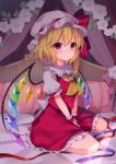  1girl arm_ribbon ascot bangs bed blonde_hair blue_ribbon blush bow commentary_request crystal curtains eyebrows_visible_through_hair flandre_scarlet flower frilled_shirt_collar frills hair_between_eyes hat hat_bow highres leaf long_hair looking_at_viewer mob_cap one_side_up parted_lips petticoat pillow rainbow_order red_bow red_eyes red_ribbon red_skirt red_vest ribbon ruhika seiza shirt sitting skirt skirt_set touhou v_arms vest white_flower white_hat white_shirt wings wrist_cuffs yellow_neckwear 