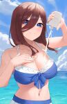  1girl applying_sunscreen bikini blue_bikini blue_eyes bottle breasts brown_hair cleavage closed_mouth collarbone day frilled_bikini frills go-toubun_no_hanayome gomashiwo_o hair_between_eyes hand_on_own_chest highres holding holding_bottle large_breasts long_hair looking_at_viewer nakano_miku navel ocean outdoors sky solo swimsuit 