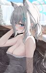  1girl absurdres animal_ear_fluff animal_ears blue_archive blue_eyes blue_halo blush breasts cleavage cross_hair_ornament day extra_ears grey_hair hair_between_eyes hair_ornament halo highres kurone_(kurone_ryuo) large_breasts looking_at_viewer medium_hair naked_towel onsen open_mouth partially_submerged shiroko_(blue_archive) solo towel water white_towel wolf_ears 