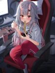  1girl blush chair chopsticks commentary computer computer_keyboard cup_ramen double-parted_bangs eating feet_on_chair food full_body gabuchi grey_hair hair_over_shoulder headphones headphones_removed highres holding holding_chopsticks holding_food hololive horns long_hair looking_at_viewer monitor monster_energy nakiri_ayame nintendo_switch noodles on_chair oni pants pillow red_eyes red_pants red_streaks shirt short_sleeves sidelighting sidelocks sitting skin-covered_horns socks sweat sweatdrop symbol-only_commentary white_shirt white_socks 