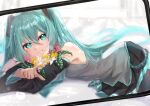  1girl absurdres aqua_eyes aqua_hair aqua_necktie aquact bare_shoulders birthday black_skirt black_sleeves black_thighhighs blue_necktie blurry blurry_background cellphone cellphone_photo detached_sleeves flower grey_shirt grin hair_between_eyes hair_ornament hatsune_miku highres holding holding_flower index_finger_raised long_hair looking_at_viewer lying miniskirt necktie on_side on_stomach orange_flower phone pink_flower pleated_skirt pointing shirt skirt sleeveless sleeveless_shirt smartphone smile solo teeth thighhighs twintails twitter_username very_long_hair vocaloid white_flower yellow_flower 