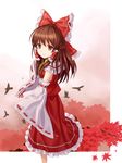  ascot autumn bird bow brown_eyes brown_hair crow detached_sleeves hair_bow hakurei_reimu highres leaf light_smile maple_leaf solo touhou tree tucana 