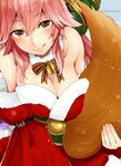  animal_ears bare_shoulders blush breasts christmas cleavage dress eyelashes fate/grand_order fate_(series) fox_ears fox_girl fox_tail fur_trim half-closed_eyes highres large_breasts licking_lips looking_at_viewer narushima_kanna off_shoulder pink_hair red_dress smile tail tamamo_(fate)_(all) tamamo_no_mae_(fate) tongue tongue_out wide_sleeves 