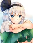  bangs black_bow blue_eyes bow closed_mouth commentary_request crossed_arms eyebrows_visible_through_hair eyelashes green_skirt hair_bow konpaku_youmu looking_at_viewer nagare sad short_sleeves silver_hair sitting skirt solo touhou 