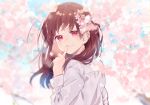  bangs blurry blush brown_hair cherry_blossoms depth_of_field finger_to_mouth floating_hair flower hair_flower hair_ornament highres long_hair long_sleeves looking_at_viewer looking_back omutatsu original outdoors petals red_eyes shirt sidelocks smile solo standing tree upper_body white_shirt wind 