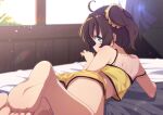  1girl absurdres ahoge ass bare_arms bare_shoulders barefoot bed_sheet blue_eyes blurry blurry_background brown_hair camisole commentary_request curtains day depth_of_field highres hololive indoors iyokan_momiji looking_at_viewer looking_back lying natsuiro_matsuri natsuiro_matsuri_(matsuri's_day_off) on_stomach shirt short_shorts shorts side_ponytail soles solo sunlight virtual_youtuber yellow_camisole yellow_shirt 