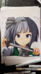  1girl art_tools_in_frame artist_name blue_eyes bow bowtie closed_mouth collared_shirt commentary_request dated frown green_vest grey_bow grey_bowtie grey_hair grey_hairband hairband highres holding holding_sword holding_weapon katana konpaku_youmu looking_at_viewer mist9801km photo_(medium) sheath shirt solo sword touhou traditional_media unsheathing upper_body vest weapon white_shirt 