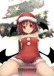  1girl alternate_costume bangs bare_legs bare_shoulders blurry blurry_background box breasts christmas_tree collarbone demon_wings dress fur_trim futatsuki_eru gift gift_box hair_between_eyes hat head_wings highres koakuma looking_at_viewer medium_breasts open_mouth pom_pom_(clothes) red_dress red_eyes red_hair santa_costume santa_hat short_dress short_hair simple_background solo strapless touhou white_background wings 
