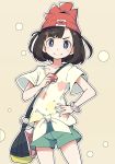  bag beanie black_hair blue_eyes commentary eyebrows_visible_through_hair floral_print green_shorts hand_on_hip handbag hat holding holding_poke_ball ixy mizuki_(pokemon) poke_ball poke_ball_(generic) pokemon pokemon_(game) pokemon_sm red_hat shirt short_hair short_sleeves shorts simple_background smile solo tied_shirt z-ring 