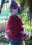  1girl blue_hair blue_kimono bridge commentary doll floral_print flower hair_bun hair_flower hair_ornament highres idolmaster idolmaster_shiny_colors japanese_clothes kimono looking_at_viewer morino_rinze outdoors parted_lips red_cloak red_eyes short_hair solo tree_shade 