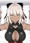  ahoge arms_up bangs bare_shoulders black_bow bow breasts cleavage cleavage_cutout commentary_request dark_skin eyebrows_visible_through_hair eyes_visible_through_hair fate/grand_order fate_(series) hair_bow indoors large_breasts looking_at_viewer lying medium_hair mitsukazu_(nijigen_complex) okita_souji_(alter)_(fate) okita_souji_(fate)_(all) on_back on_bed open_mouth pillow pillow_grab sleeveless solo upper_body white_hair white_pillow yellow_eyes 