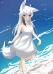  1girl absurdres ahoge animal_ear_fluff animal_ears bare_arms bare_shoulders barefoot blush breasts closed_mouth collarbone commentary_request day dress fox_ears fox_girl fox_tail grey_eyes grey_hair highres kuronagi_(mitora_uwu) looking_at_viewer ocean original outdoors sleeveless sleeveless_dress small_breasts smile solo standing standing_on_one_leg tail water white_dress white_hair 