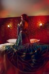  1girl bed bedroom circlet cosplay costume dress freckles full_body helly_von_valentine_(disharmonica) indoors jewelry kneeling lens_flare looking_afar makeup necklace no_bra on_bed parted_lips pendant photo pillow red_hair robe side_braids solo the_witcher triss_merigold undressing 