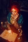  1girl book breasts circlet cosplay costume dress flask freckles from_above helly_von_valentine_(disharmonica) indoors jewelry makeup medium_breasts necklace no_bra parted_lips pendant photo red_hair robe side_braids sitting solo table the_witcher triss_merigold upper_body 