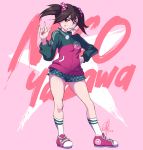  black_hair blush commentary eyebrows_visible_through_hair hand_on_hip highres love_live! love_live!_school_idol_project pink_background red_eyes scrunchie shoes short_shorts short_twintails shorts signature simple_background sneakers socks standing string_in_mouth thighs track_suit triple-q twintails yazawa_nico 