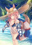  animal_ear_fluff animal_ears bangs beach bikini blue_bikini blush breasts cloud commentary_request day ears_through_headwear fate/grand_order fate_(series) fox_ears fox_girl fox_tail hair_between_eyes hair_tie hat highres holding innertube large_breasts long_hair looking_at_viewer low_ponytail nagishiro_mito ocean outdoors palm_tree pink_hair see-through shirt sidelocks sky solo standing straw_hat sun_hat swimsuit tail tamamo_(fate)_(all) tamamo_no_mae_(swimsuit_lancer)_(fate) tree wet wet_clothes wet_shirt wet_t-shirt yellow_eyes 