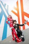  1boy 1girl bangs black_bodysuit black_hair blue_eyes bodysuit cosplay couple darling_in_the_franxx gloves green_eyes hair_ornament hairband hetero hiro_(darling_in_the_franxx) hiro_(darling_in_the_franxx)_(cosplay) horns long_hair oni_horns pilot_suit pink_hair red_bodysuit red_horns white_gloves white_hairband zero_two_(darling_in_the_franxx) zero_two_(darling_in_the_franxx)_(cosplay) 