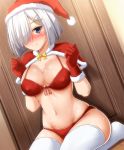  1girl alcohol bikini blue_eyes blush breasts clenched_hands closed_mouth commentary_request dutch_angle eyebrows_visible_through_hair front-tie_bikini front-tie_top gloves groin hair_ornament hair_over_one_eye hairclip hamakaze_(kantai_collection) highres kantai_collection large_breasts looking_at_viewer navel nose_blush on_floor red_bikini red_gloves revision santa_bikini santa_costume santa_gloves shawl short_hair silver_hair sitting smile solo swimsuit thighhighs wariza white_legwear zanntetu 