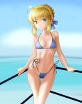  1girl against_railing ahoge artoria_pendragon_(all) bangs bare_arms bare_shoulders bikini blonde_hair blue_bikini blue_bow blue_sky blurry blurry_background blush bow braid breasts closed_mouth cloud commentary_request day depth_of_field eyebrows_visible_through_hair fate/stay_night fate_(series) green_eyes groin hair_between_eyes hair_bow highleg highleg_bikini highres horizon looking_at_viewer navel ocean outdoors railing saber side-tie_bikini sidelocks sky small_breasts smile solo standing swimsuit taka_(takahirokun) water 