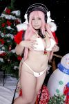  1girl asian breasts chouzuki_maryou christmas christmas_tree cosplay headphones highres large_breasts nitroplus photo pink_hair plump solo super_sonico super_sonico_(cosplay) 