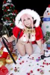  1girl asian breasts chouzuki_maryou christmas christmas_tree cosplay headphones highres large_breasts nitroplus photo pink_hair plump solo super_sonico super_sonico_(cosplay) 