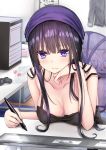  1girl bare_shoulders black_hair black_shirt blue_eyes blue_headwear blurry blush breasts chin_rest cleavage closed_mouth collarbone computer depth_of_field frown hand_up highres holding holding_stylus indoors large_breasts long_hair looking_at_viewer original piripun shirt sidelocks solo stylus table tablet_pc 