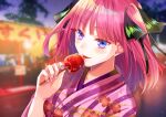  1girl bangs black_ribbon blue_eyes blunt_bangs blush butterfly_hair_ornament candy_apple collarbone commentary_request eyebrows_visible_through_hair festival food go-toubun_no_hanayome hair_ornament holding holding_food japanese_clothes kimono looking_at_viewer multicolored_nails nail_polish nakano_nino outdoors pink_hair pink_kimono ribbon shiratsu tongue tongue_out twintails yukata 