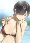  1girl araido_kagiri bangs bare_arms bare_shoulders bikini black_hair blurry blurry_background blush breasts cleavage closed_mouth collarbone hair_between_eyes halterneck hands_up highres large_breasts looking_at_viewer mole mole_on_breast original purple_eyes red_bikini short_hair sidelocks smile solo strap_pull swimsuit upper_body v-shaped_eyebrows 