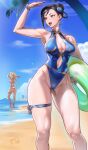  2girls absurdres beach bikini black_hair blonde_hair blue_nails blue_one-piece_swimsuit blue_sky bracelet braid brown_eyes cammy_white chun-li commentary day double_bun earrings hair_bun hat highleg highleg_one-piece_swimsuit highres holding holding_swim_ring jewelry juaag_acgy leg_ribbon light_rays linea_alba multiple_girls nail_polish ocean one-piece_swimsuit open_mouth outdoors palm_tree purple_hair red_bikini ribbon sky standing street_fighter sun_hat swim_ring swimsuit thigh_ribbon tree twin_braids 