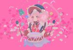  1girl :d black_bow blue_hat bow character_name commentary cookie_run cookie_run:_kingdom cropped_torso drum drumsticks film_grain flower hair_rings hat holding holding_drumsticks humanization instrument long_sleeves looking_at_viewer macaron_cookie macaron_cookie_(lively_pungmulnori) mohawk official_alternate_costume open_mouth parted_bangs pink_background pink_eyes pink_flower pink_hair puffy_long_sleeves puffy_sleeves red_sweater reed simple_background smile solo star_(symbol) sweater symbol-only_commentary white_flower 