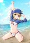  1girl absurdres ahoge artoria_pendragon_(all) baseball_cap beach bikini blonde_hair blue_eyes blue_headwear blush breasts cloud commentary_request day eyebrows_visible_through_hair fate/grand_order fate_(series) hair_through_headwear hat highres itachi_class kneeling looking_at_viewer mysterious_heroine_xx_(foreigner) navel outdoors ponytail shrug_(clothing) side-tie_bikini smile solo swimsuit water white_bikini 