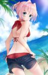  1girl ass beach bikini black_shorts blue_eyes blue_sky cloud cowboy_shot day dutch_angle from_behind hair_ornament highres horizon kantai_collection looking_back ocean outdoors pink_hair ponytail red_bikini shiranui_(kantai_collection) short_hair short_ponytail shorts sky solo standing swimsuit u_yuz_xx undressing water 