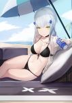  1girl anizi_(anizi9621) bangs beach bikini black_bikini blunt_bangs breasts cleavage collarbone commentary_request eyebrows_visible_through_hair girls_frontline green_eyes hair_ornament highres hk416_(girls_frontline) jacket long_hair looking_at_viewer monster_energy navel outdoors see-through silver_hair sitting smile solo swimsuit umbrella 