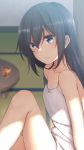  1girl bangs bare_arms bare_shoulders black_hair blue_eyes blurry blurry_background bow collarbone commentary_request copyright_request cup depth_of_field dress drink drinking_glass eyebrows_behind_hair hair_between_eyes highres indoors knee_up long_hair nagami_yuu parted_lips sitting sleeveless sleeveless_dress solo table white_bow white_dress 