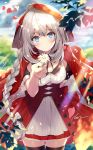  1girl black_legwear blue_eyes blurry braid breasts buttons cloak cowboy_shot day depth_of_field dress fate/grand_order fate_(series) flower highres holding holding_flower hood leaf leaves_in_wind little_red_riding_hood long_hair looking_at_viewer marie_antoinette_(fate/grand_order) medium_breasts necomi petals signature silver_hair single_braid smile solo standing sunlight thighhighs very_long_hair white_dress white_flower zettai_ryouiki 