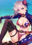  1girl american_flag_bikini asymmetrical_hair bangs beach belt bikini blue_eyes blue_jacket blue_sky blush breasts brown_gloves buckle bun_cover cleavage cloud collarbone commentary_request cowboy_shot day elbow_gloves fate/grand_order fate_(series) flag_print gloves hair_bun highres jacket large_breasts long_hair looking_at_viewer miyamoto_musashi_(fate/grand_order) miyamoto_musashi_(swimsuit_berserker)_(fate) navel nijimaarc ocean open_mouth outdoors pink_hair shrug_(clothing) single_elbow_glove sky smile solo swept_bangs swimsuit toned 