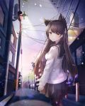  1girl animal_ears atago_(azur_lane) atago_(school_daydream)_(azur_lane) azur_lane bangs black_legwear black_sailor_collar black_skirt breasts brown_hair building cat_ears closed_mouth commentary_request eyebrows_visible_through_hair hair_ribbon highres long_hair looking_at_viewer looking_back medium_breasts outdoors pantyhose pleated_skirt pole ribbon sailor_collar school_uniform serafuku shiro_(acad1213) shirt skirt smile snowing solo very_long_hair white_ribbon white_shirt yellow_eyes 