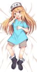  1girl bangs bed_sheet blonde_hair blue_shirt blush boots choir_(artist) commentary dakimakura eyebrows_visible_through_hair flat_cap full_body grey_shorts hair_between_eyes hand_on_own_face hat hataraku_saibou highres long_hair looking_at_viewer lying on_back platelet_(hataraku_saibou) shirt short_sleeves shorts solo white_headwear yellow_eyes 