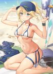  1girl absurdres ahoge ameyame artoria_pendragon_(all) bangs bare_shoulders baseball_cap beach bikini blonde_hair blue_eyes blue_headwear blue_jacket blush breasts cleavage closed_mouth collarbone fate/grand_order fate_(series) food hair_between_eyes hair_through_headwear hat highres jacket jacket_removed kneeling lance legs long_hair looking_at_viewer medium_breasts mysterious_heroine_xx_(foreigner) navel polearm ponytail popsicle sexually_suggestive shrug_(clothing) side-tie_bikini sidelocks smile solo sunlight swimsuit thigh_strap thighs twinmyniad weapon white_bikini wristband 