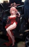  1boy 1girl aru_(blue_archive) aru_(dress)_(blue_archive) blue_archive breasts car cleavage closed_mouth collarbone commentary dress earrings gijang gloves halo highres jewelry large_breasts legs long_hair looking_at_viewer motor_vehicle necklace official_alternate_costume pink_hair pink_halo red_dress red_footwear shoes sitting smile solo_focus thighs white_gloves 