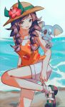  1girl :d absurdres adjusting_footwear asatte_3z bare_shoulders beach black_eyes black_hair braid brown_hat commentary_request floral_print flower hat hat_flower highres komala long_hair looking_at_viewer ocean on_shoulder open_mouth orange_shirt outdoors pokemon pokemon_(creature) pokemon_on_shoulder pokemon_usum red_flower selene_(pokemon) shirt shorts sleeveless sleeveless_shirt smile twin_braids white_shorts 