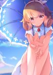  1girl azur_lane bangs bare_legs blonde_hair blue_sky carabiniere_(azur_lane) carabiniere_(refreshing_sundress)_(azur_lane) closed_mouth cloud collared_dress commentary day dress flower hair_flower hair_ornament hair_ribbon hairband holding holding_umbrella kurai_masaru looking_at_viewer outdoors parasol purple_eyes reaching_out ribbon shade short_sleeves sidelocks sky smile solo squatting sundress umbrella white_dress white_ribbon 