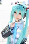  aqua_eyes aqua_hair blue_hair cosplay detached_sleeves hatsune_miku headphones headset highres long_hair necktie photo ribbon saya_(cosplayer) smile solo twintails vocaloid 