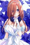 1girl arm_at_side bare_shoulders blue_eyes blue_flower blush commentary_request dress elbow_gloves eyes_visible_through_hair finger_to_mouth floral_background flower gloves go-toubun_no_hanayome hair_over_one_eye headphones headphones_around_neck long_hair looking_at_viewer nakano_miku necocafe_lili parted_lips red_hair smile solo strapless strapless_dress upper_body wedding_dress white_dress white_gloves white_headwear 