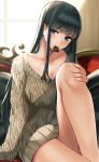  1girl bangs black_hair blue_eyes blush breasts candy chocolate chocolate_heart cleavage eyebrows_visible_through_hair food food_in_mouth heart highres long_hair looking_at_viewer nikek96 original sitting smile solo sweater 