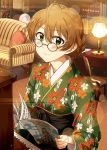  1girl ahoge ayano_yuu_(sonma_1426) bespectacled black_hakama blush book bookshelf braid brown_hair chair closed_mouth commentary_request couch cushion desk desk_lamp eyebrows_visible_through_hair floral_print glasses glint green_eyes green_kimono hair_between_eyes hakama highres holding holding_book idolmaster idolmaster_million_live! idolmaster_million_live!_theater_days indoors instrument japanese_clothes kimono lamp light_smile long_sleeves looking_at_viewer open_book piano print_kimono round_eyewear sakuramori_kaori sheet_music short_hair sitting solo tied_hair upper_body 