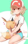  1girl artist_name ayumi_(pokemon) bangs baseball_cap black_shirt blush breast_feeding breasts brown_eyes brown_hair collarbone commentary_request eevee eyebrows_visible_through_hair gen_1_pokemon green_shorts hat heart highres holding holding_pokemon kneeling medium_breasts pokemon pokemon_(creature) pokemon_(game) pokemon_lgpe ponytail shirt short_sleeves shorts shoukichi_(shony) smile white_shirt 